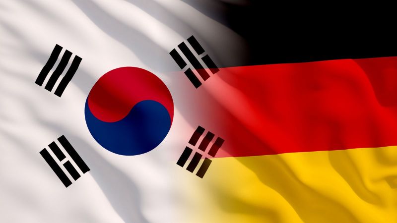 Das bild zeigt eine deutsche und eine Süd-Koreanische Flagge.