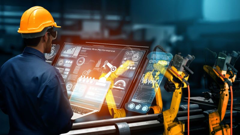 Das Bild zeigt intelligente Industrieroboterarme für den automatisierten Fertigungsprozess.